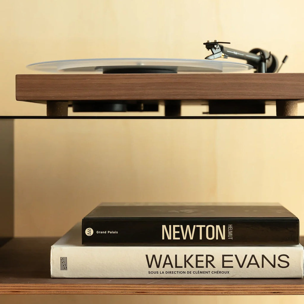 Detail van een platenspeler op het zwarte LOIA hifi-meubel met walnoten legplank voor audioapparatuur